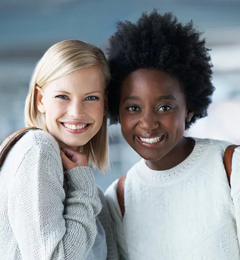 two girlfriends smiling